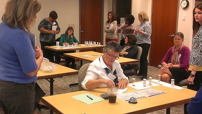 QI Advisors participating in a workshop simulation activity.